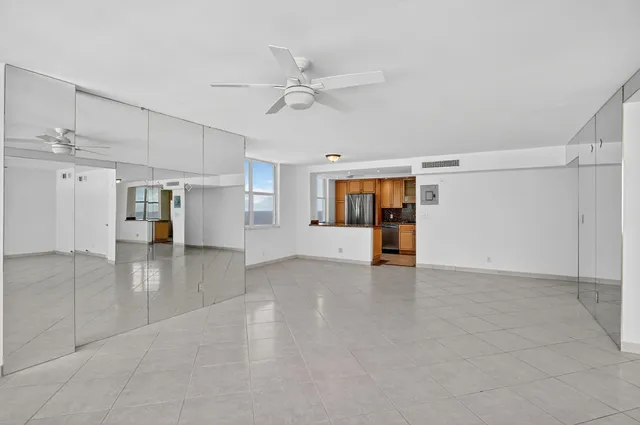 a kitchen with granite countertop a sink and white cabinets