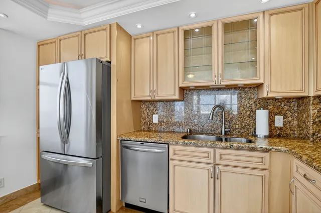 a kitchen with stainless steel appliances granite countertop a stove microwave and cabinets