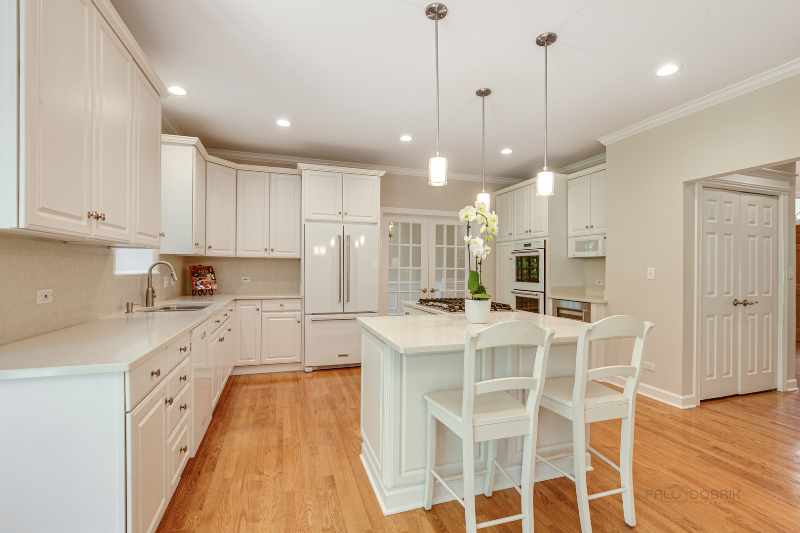1127 South Ridge Road Lake Forest, IL 60045 - Photo 11 of 35 a large kitchen with kitchen island granite countertop lots of white cabinets appliances and furniture