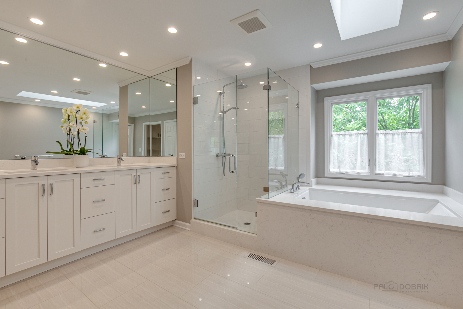 1127 South Ridge Road Lake Forest, IL 60045 - Photo 19 of 35 a large bathroom with a large mirror vanity and shower