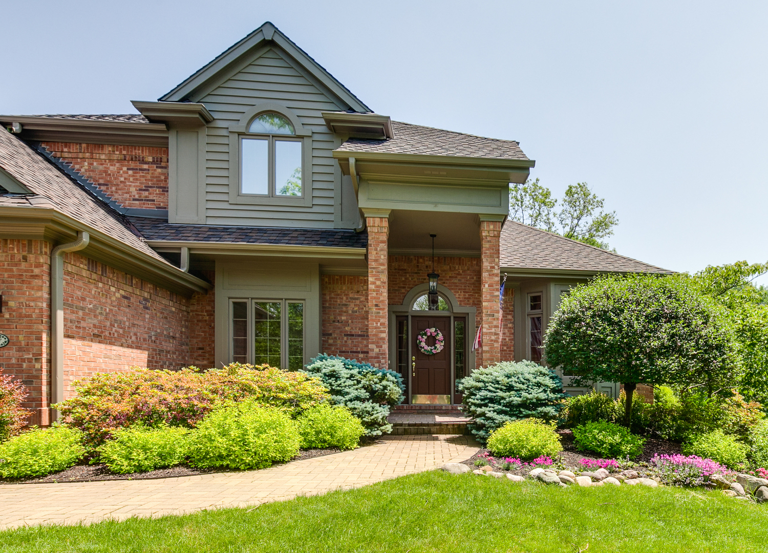 1127 South Ridge Road Lake Forest, IL 60045 - Photo 3 of 35 a front view of a house with garden