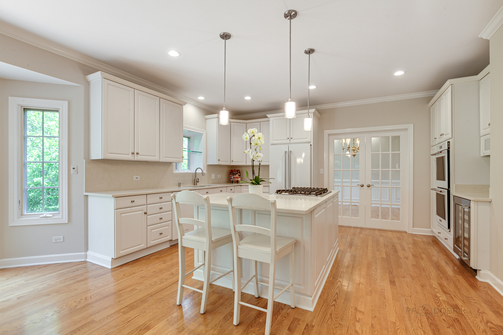 1127 South Ridge Road Lake Forest, IL 60045 - Photo 10 of 35 a large kitchen with kitchen island white cabinets and stainless steel appliances
