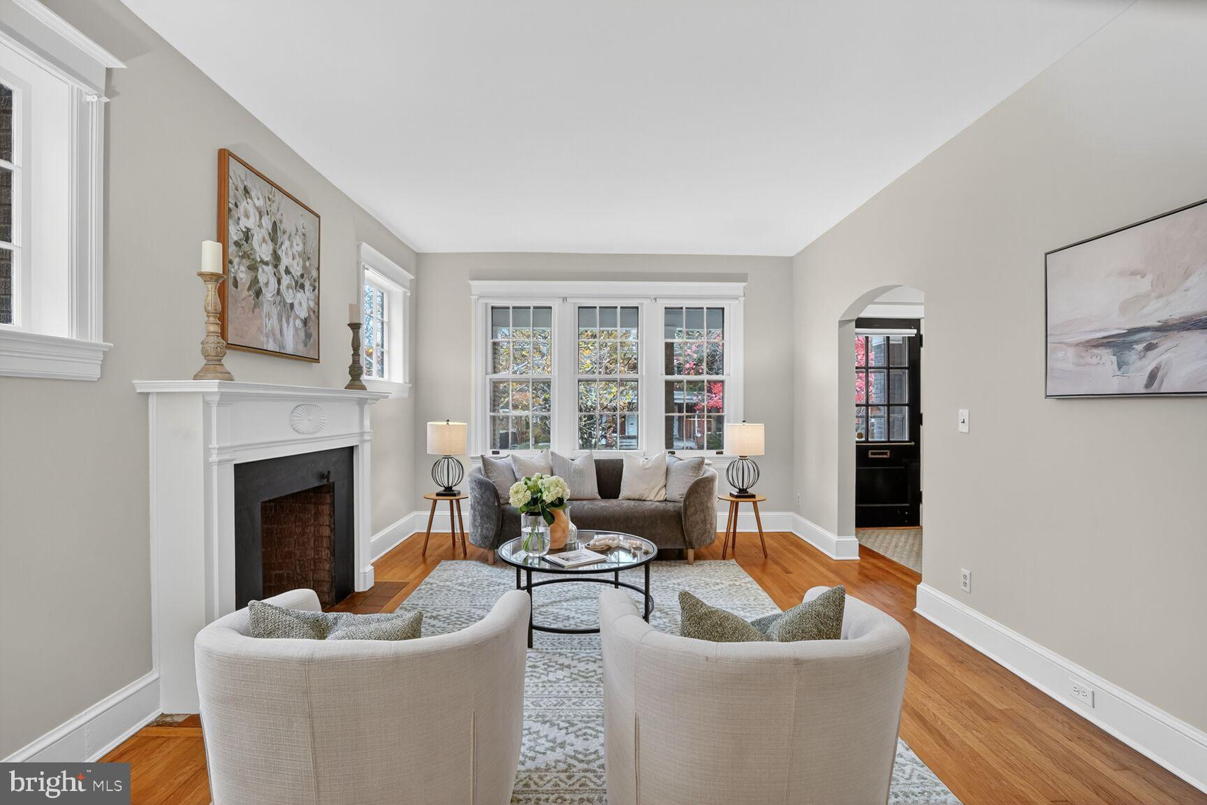 4214 37th Street Northwest Washington, DC 20008 - Photo 5 of 41 a living room with furniture a fireplace and a large window