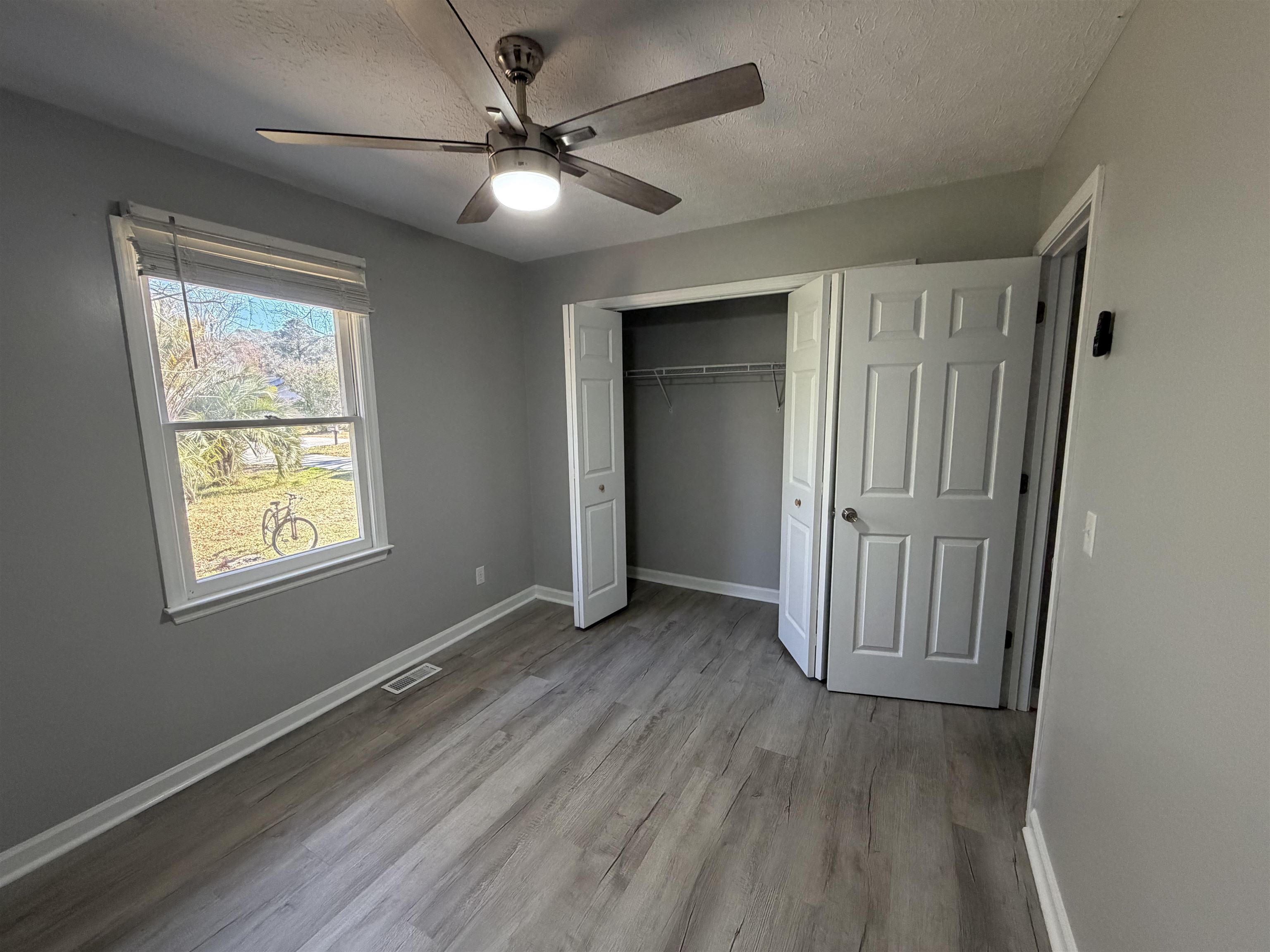 607 Geddings Drive Myrtle Beach, SC 29588 - Photo 13 of 21 Unfurnished bedroom with a textured ceiling, ceiling fan, light wood-style floors, and a closet