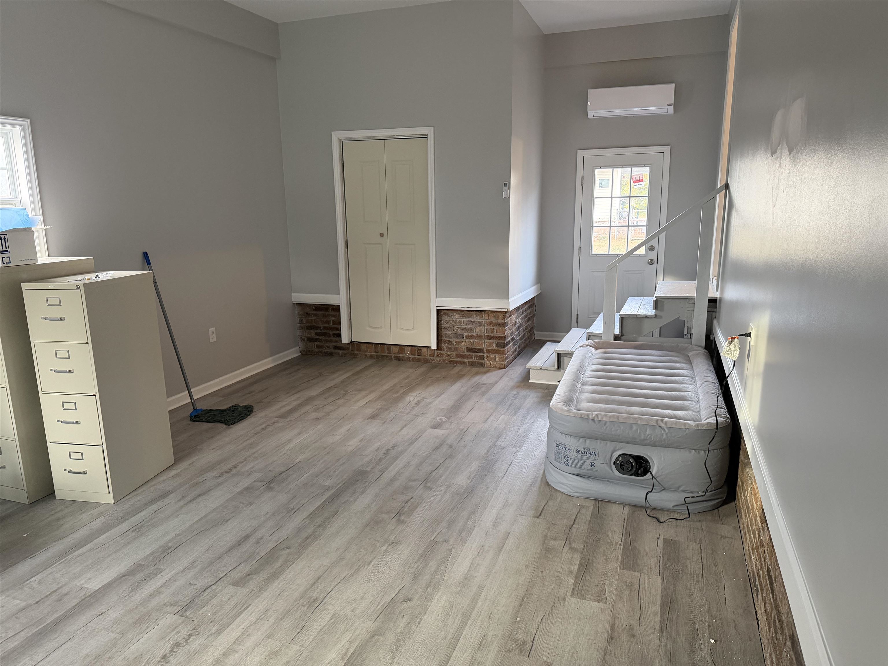 607 Geddings Drive Myrtle Beach, SC 29588 - Photo 21 of 21 Misc room with light wood-style floors, brick wall, and a wall mounted AC