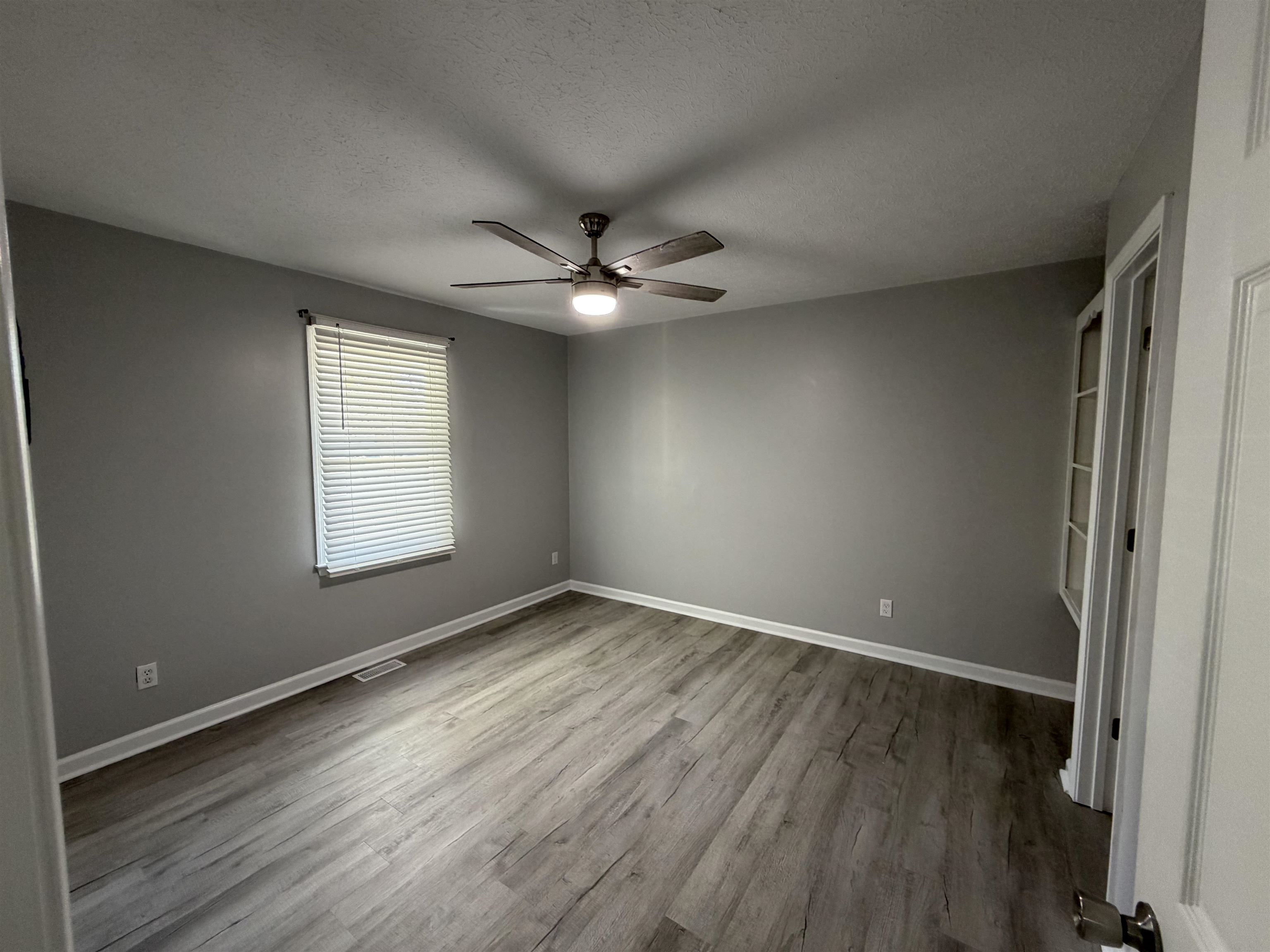 607 Geddings Drive Myrtle Beach, SC 29588 - Photo 9 of 21 Unfurnished bedroom featuring a textured ceiling, light wood-style floors, and a ceiling fan