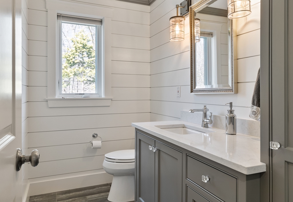 55 Depot Road Boxford, MA 01921 - Photo 24 of 42 a bathroom with a granite countertop toilet sink and mirror