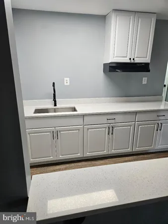 a kitchen with white cabinets