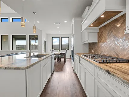 a kitchen with counter top space a sink and appliances