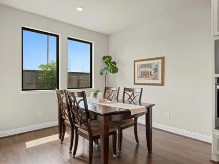 a view of a dining room with furniture window and wooden floor