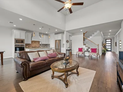a living room with furniture and kitchen view