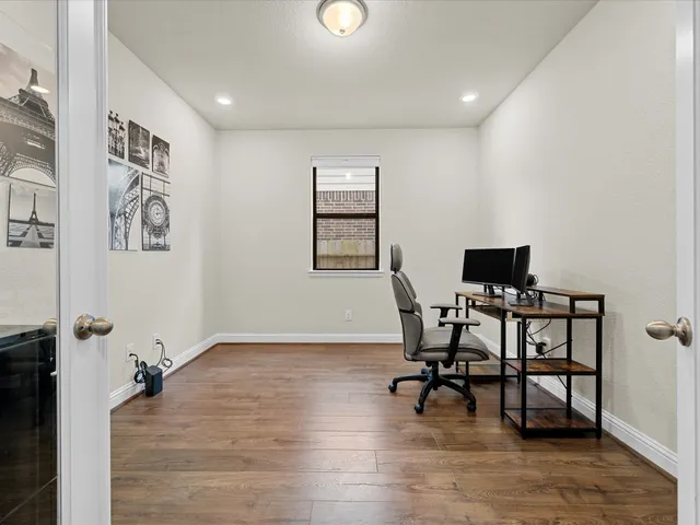 a view of a workspace with furniture and a window
