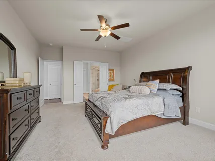 a bedroom with a bed and a chandelier