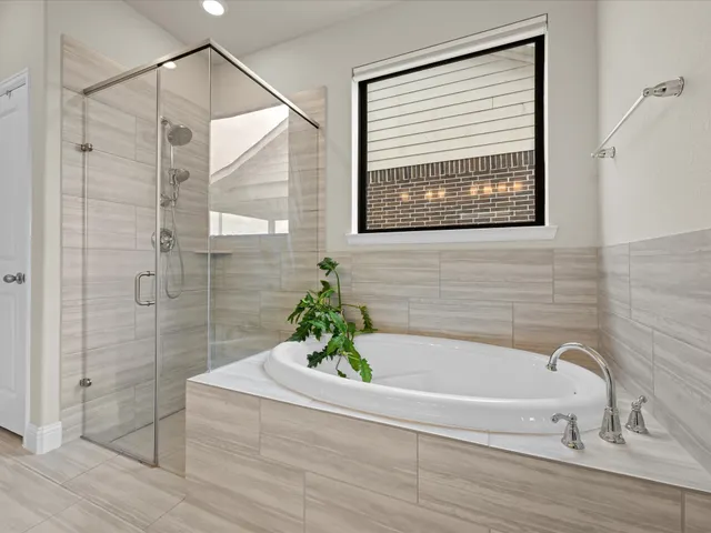 a bathroom with a bathtub and shower