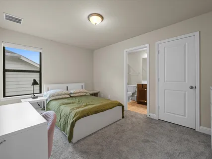 a bedroom with two beds and a window