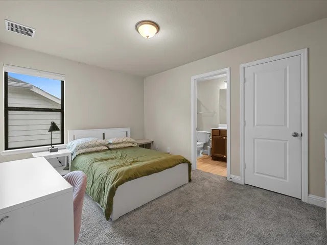 a bedroom with two beds and a window