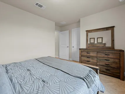 a bedroom with a bed and a mirror