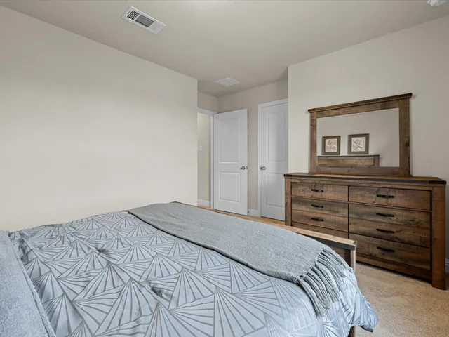 a bedroom with a bed and a mirror