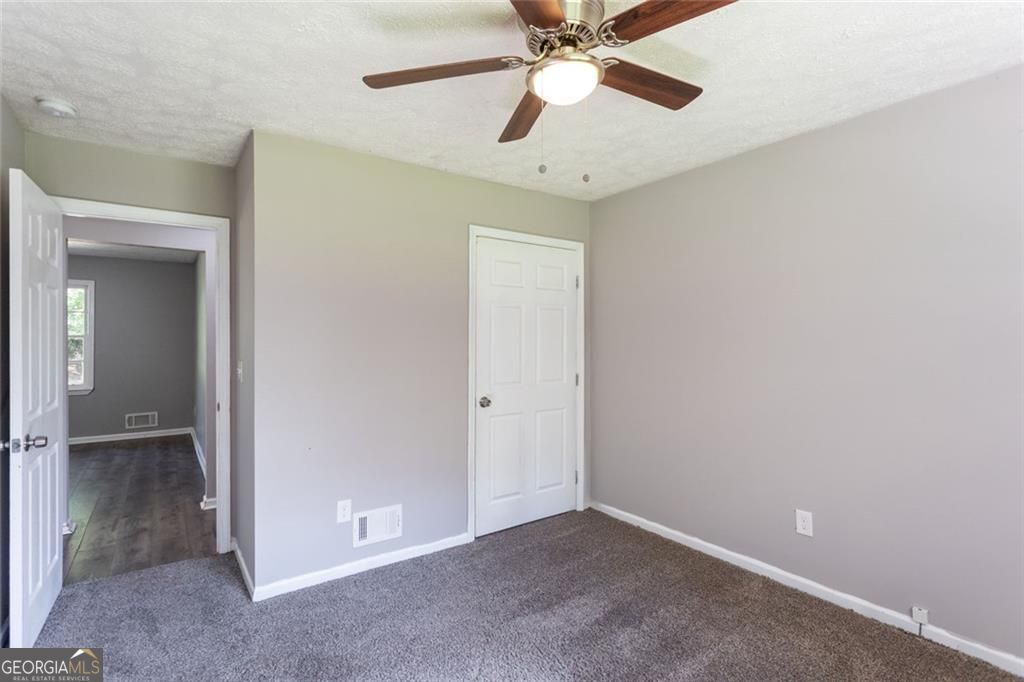 908 East Marable Street Monroe, GA 30656 - Photo 15 of 26 an empty room with closet and a chandelier fan