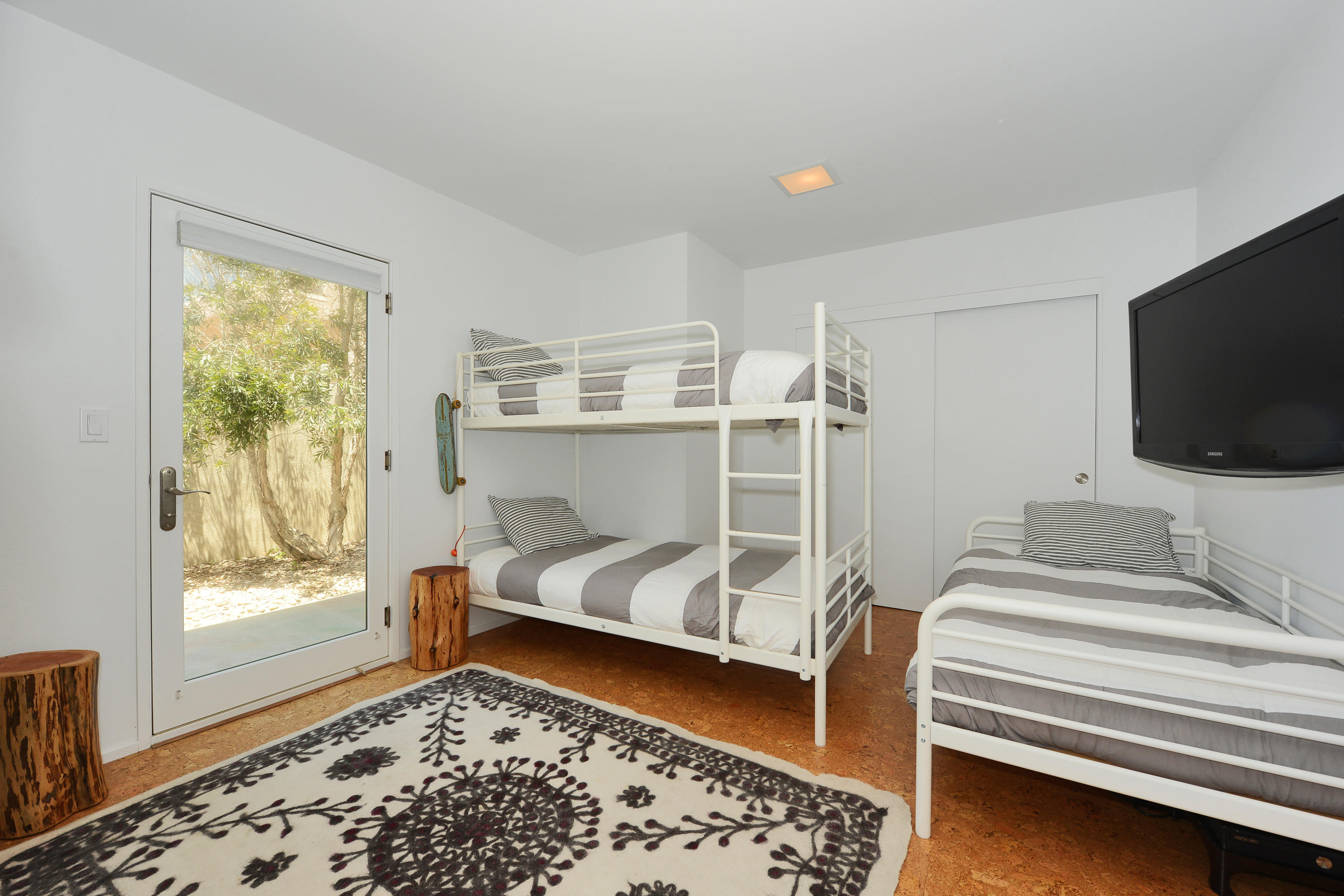 3600 Ocean Drive Oxnard, CA 93035 - Photo 12 of 30 a bedroom with a bed and a flat tv screen on the dresser