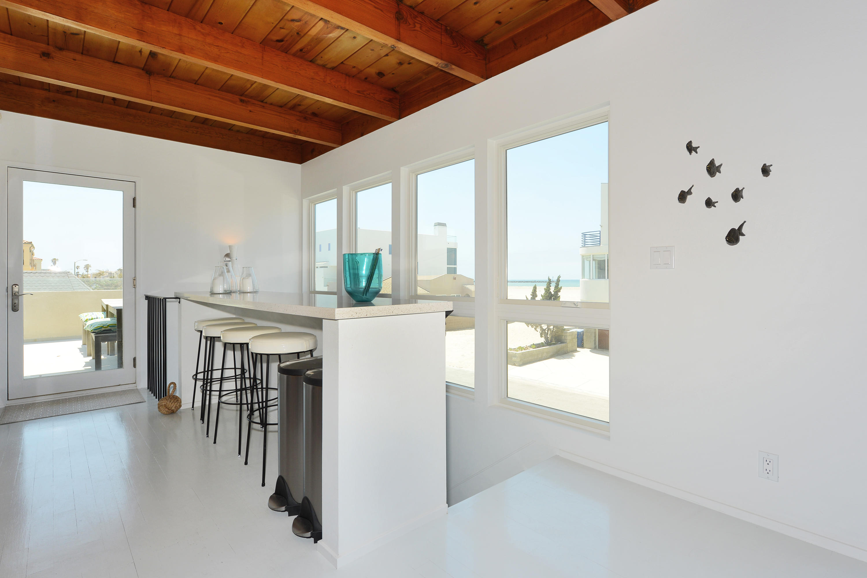 3600 Ocean Drive Oxnard, CA 93035 - Photo 17 of 30 a dining room with furniture and a kitchen view