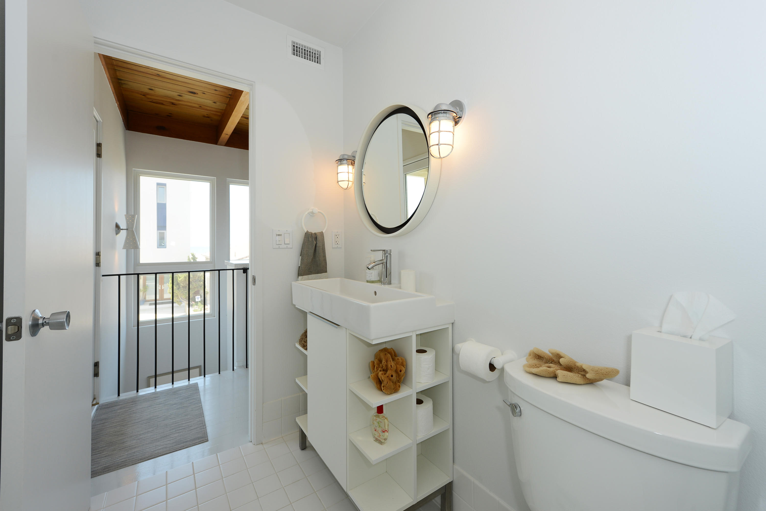 3600 Ocean Drive Oxnard, CA 93035 - Photo 20 of 30 a bathroom with a toilet a sink and a mirror