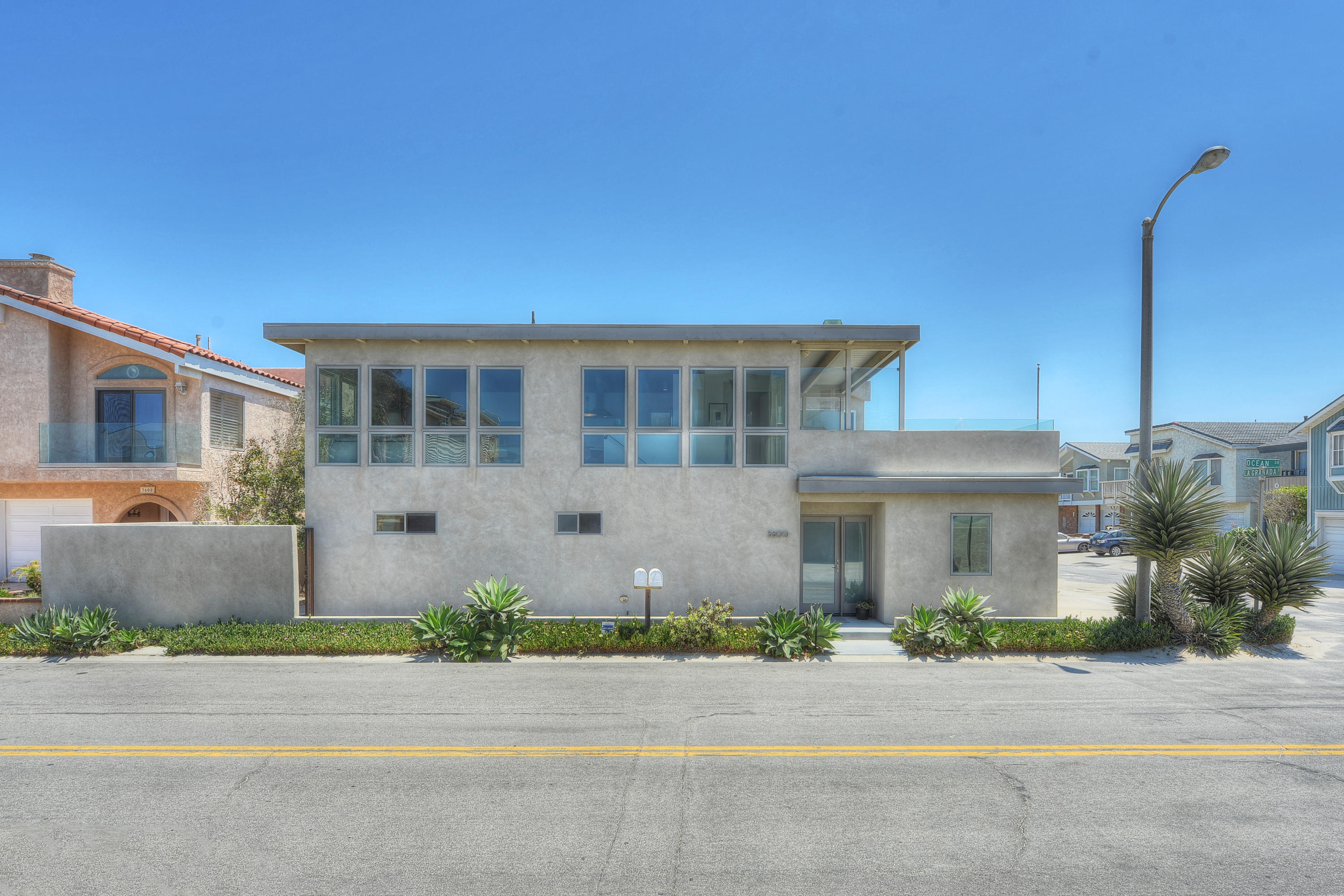 3600 Ocean Drive Oxnard, CA 93035 - Photo 3 of 30 a front view of a house with a garden and garage