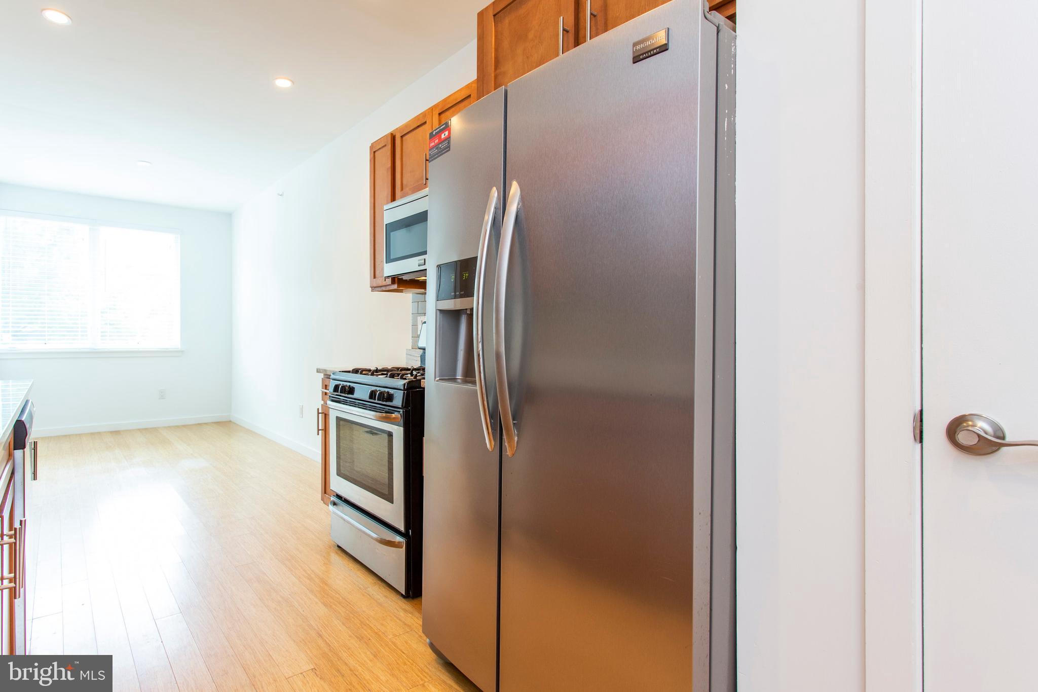 1519 Ogden Street, Unit 1 Philadelphia, PA 19130 - Photo 9 of 19 a kitchen with a refrigerator and a sink