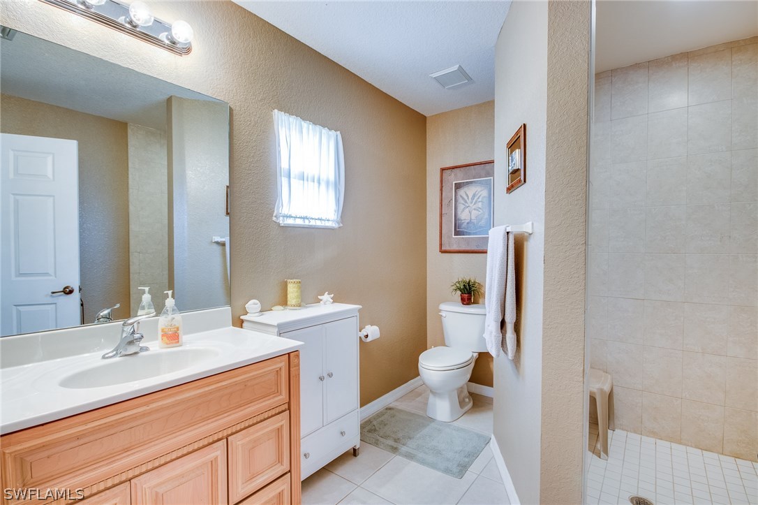 30073 Alder Road Punta Gorda, FL 33982 - Photo 17 of 25 a bathroom with a sink mirror vanity and toilet