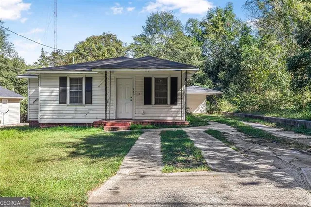 a front view of a house with garden