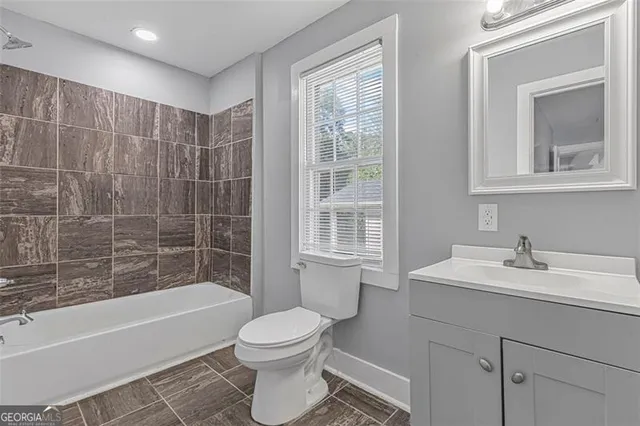 a bathroom with a sink toilet a vanity and bathtub