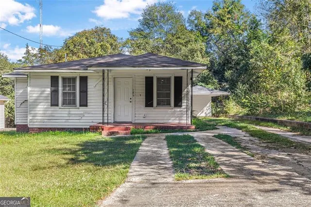 a front view of a house with garden