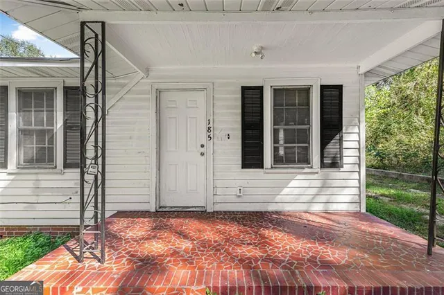 a view of house with backyard and glass windows