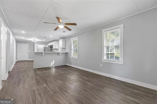 a view of wooden floor and windows in a room