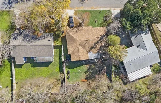 an aerial view of a house with a yard