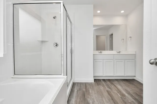 a view of bathroom with a sink mirror and shower
