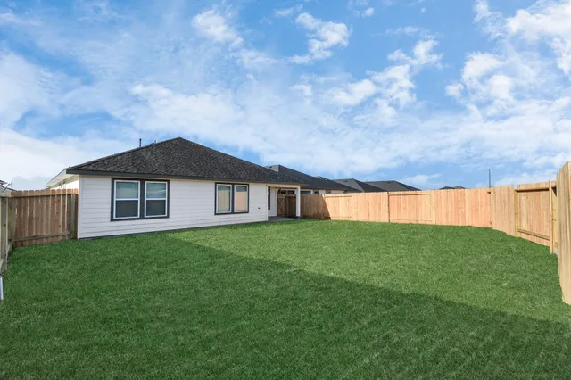 a backyard of a house with lots of green space