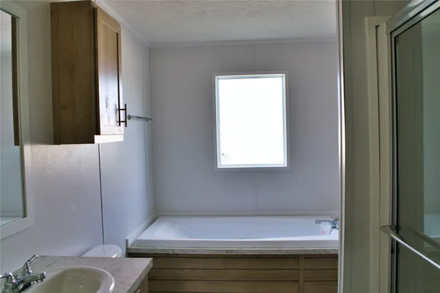 a bathroom with a bathtub and a toilet