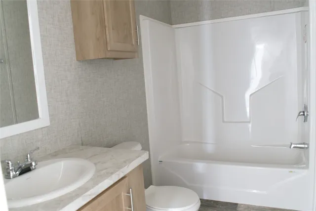 a bathroom with a sink toilet and bathtub