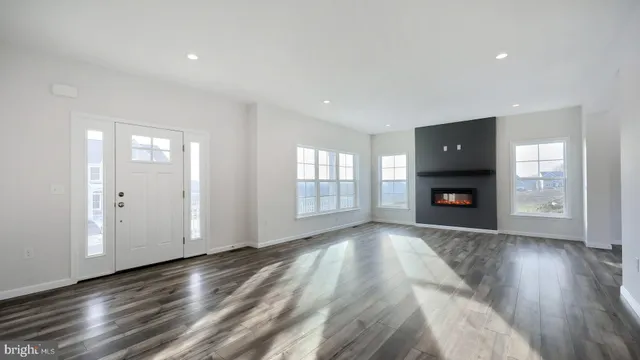 a view of an empty room with window and fire place
