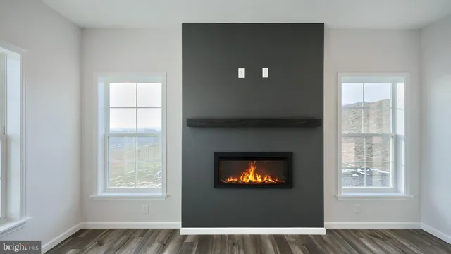a view of an empty room with a window and fire place
