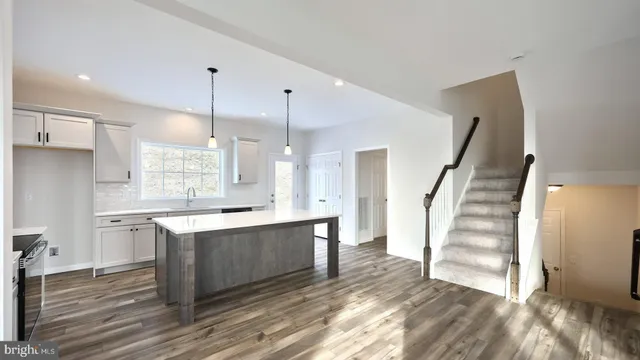 a view of kitchen with cabinets and wooden floor