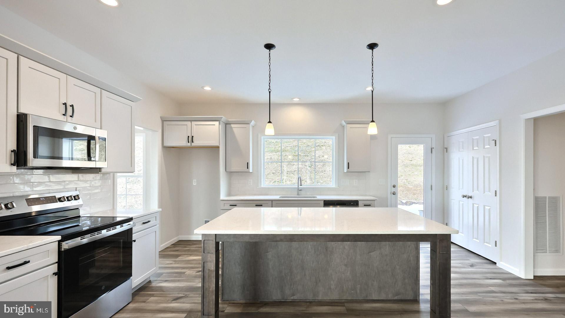 220 Copper Ridge Drive Newmanstown, PA 17073 - Photo 22 of 31 a kitchen with kitchen island a sink stainless steel appliances and cabinets