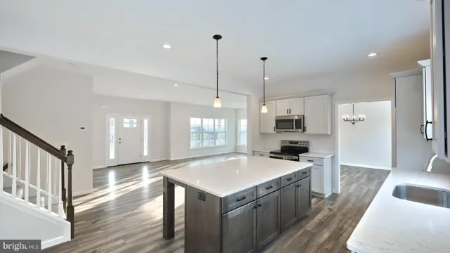 a kitchen with a stove sink and a refrigerator