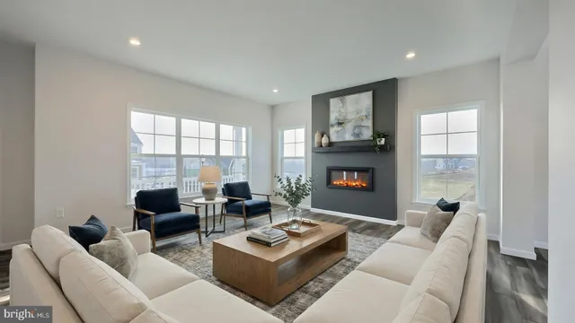 a living room with furniture large window and a fireplace