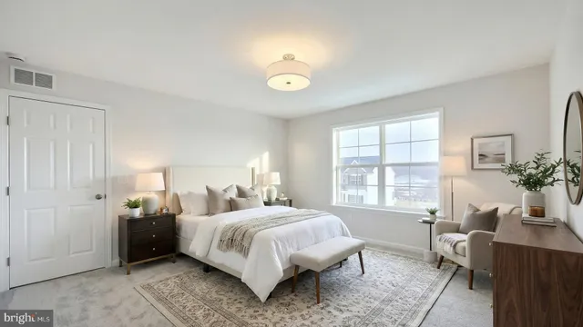 a bedroom with a bed and a table in it with window