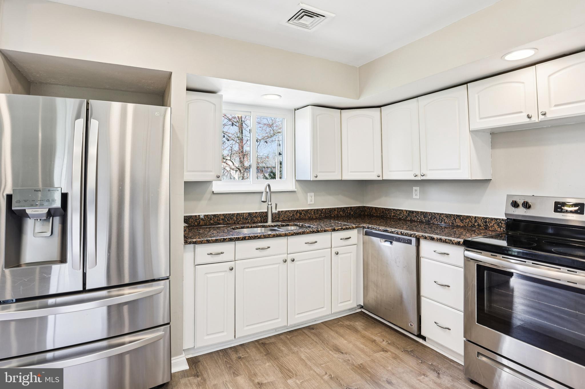 15 Brimfield Road Audubon, PA 19403 - Photo 13 of 41 a kitchen with granite countertop white cabinets and stainless steel appliances