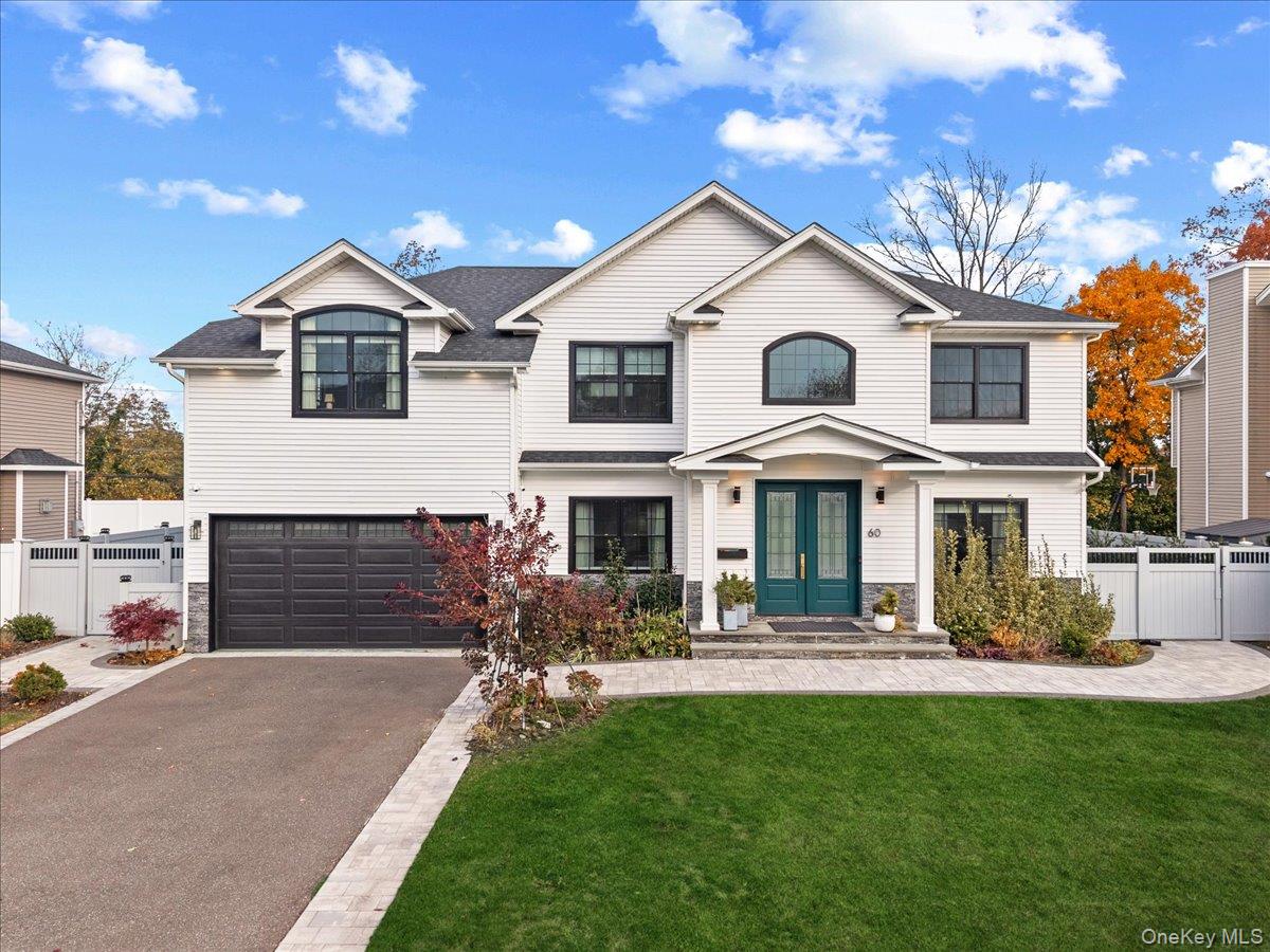 View of front of property with french doors, driveway, a garage, and a shingled roof