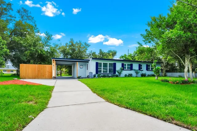 a front view of a house with yard patio and green space