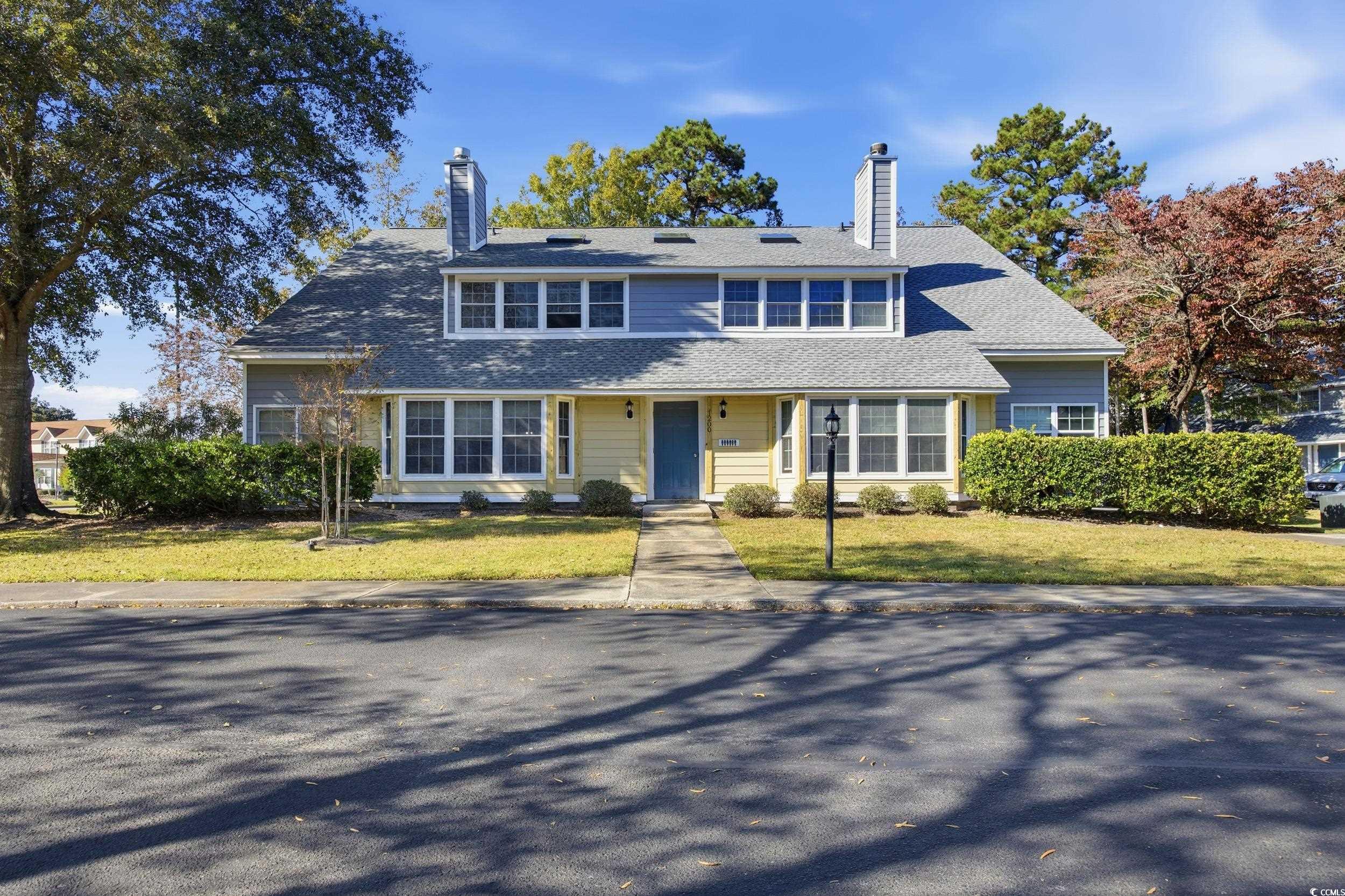 1200 Benna Drive, Unit 1C Myrtle Beach, SC 29577 - Photo 1 of 37 View of front of property with a chimney, a front yard, and covered porch